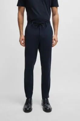 Pantalones slim fit de punto técnico elástico