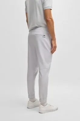 Pantalones tapered fit de tejido elástico repelente al agua